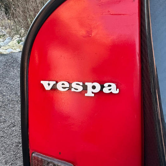 Vespa P200E Front Logo Badges — Vespa P200E logo badges designed for late 70s and early 80s scooters.