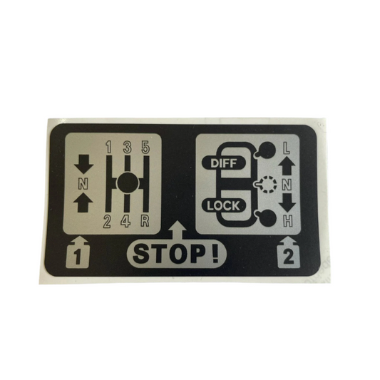 AWR1183 / BTR9547 – Transmission Warning Label (Cubby Box) — Manual — Land Rover warning sticker fitted inside the cubby box on manual transmission models of the Range Rover Classic and Discovery 1. Reminds drivers of transmission safety instructions. Ideal for restoration or replacement.