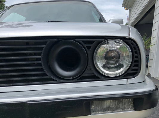 Cold Air Intake Headlight Replacement For BMW E30 — • Replaces a high beam headlight on either passenger or drivers side. • 3 inch outlet, easily connectable to air box with 3 inch flex hose. • Will also connect to some aftermarket inline airboxes • There is tight clearance due to the core support behind the drivers side headlight but will still accept 3 inch hose. • If connected to hose, it will be hard to put on a hose clamp but it will fit at the right angles. • Only tested on late model headlight and o…
