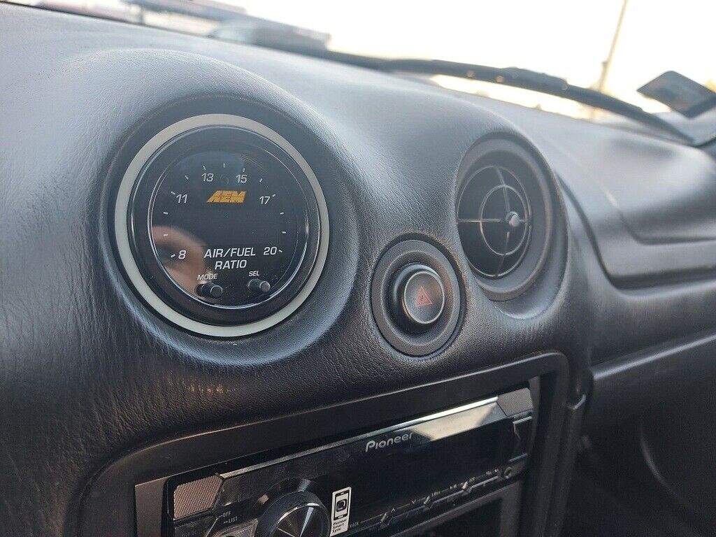 MX5 AEM Wideband Gauge Vent Mount — Fits AEM Wideband O2 controller into the "eye ball" air vent inlets in 2002 Mazda MX-5 NBFL. It is compatible with all MX-5s from 1990 to 2004, as far as I know these models had the same vent holes.