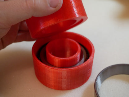 Grease packing tool for Land Rover Defender wheel bearings — This tool helps you push grease quick and clean into the wheel bearings of the Land Rover Defender in the rear. You put the bearing like shown in to the cup. Than you put some grease in it, put the pusher in the correct orientation (as you can also see in the pictures) in it and push. Take the bearing out (some slaps on the back required) and check if it has enough grease.