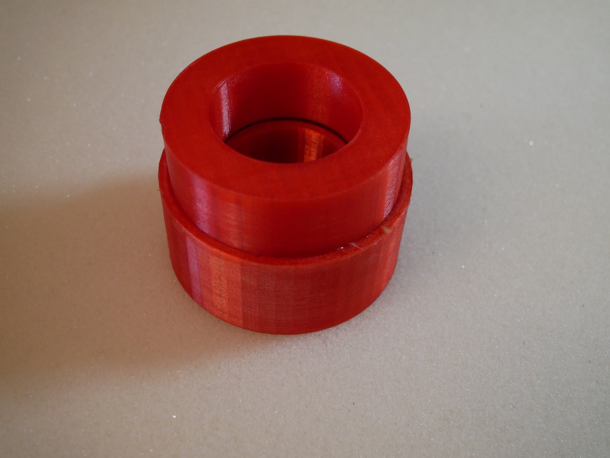 Grease packing tool for Land Rover Defender wheel bearings — This tool helps you push grease quick and clean into the wheel bearings of the Land Rover Defender in the rear. You put the bearing like shown in to the cup. Than you put some grease in it, put the pusher in the correct orientation (as you can also see in the pictures) in it and push. Take the bearing out (some slaps on the back required) and check if it has enough grease.